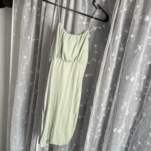 Body-fit sage green dress.